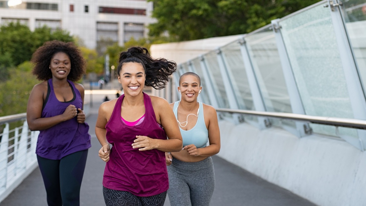 Women running across bridge